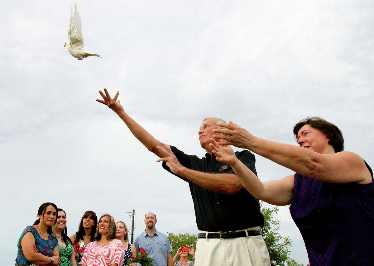C.H. Cain and his wife, Suzy Cain, release a dove in memory of their daughter, Jessica Cain, during a tribute site dedication at Highland Bayou Park in 2012, in La Marque.
