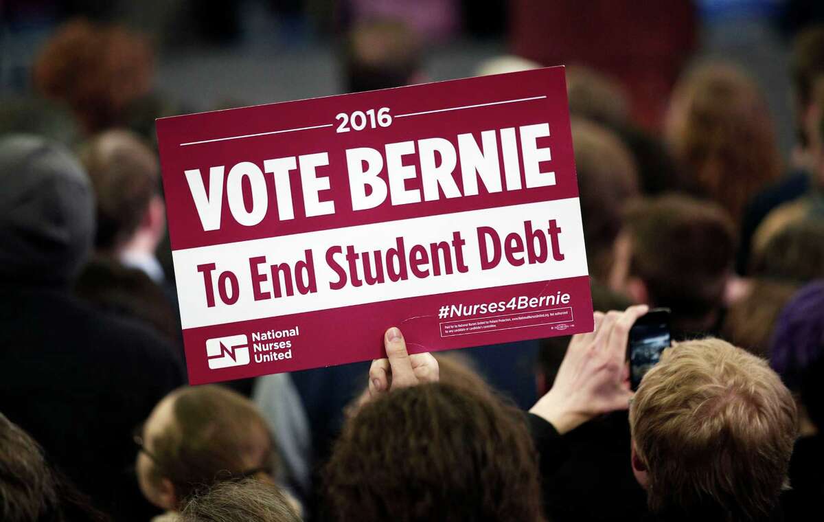 A supporter of U.S. Senator and Democratic Presidential Candidate Bernie Sanders holds a sign at Sanders' first campaign rally in Michigan at Eastern Michigan University on Feb. 15 in Ypsilanti, Michigan. The allure of free tuition is tempting but puts the nation on the slippery slope to socialism.