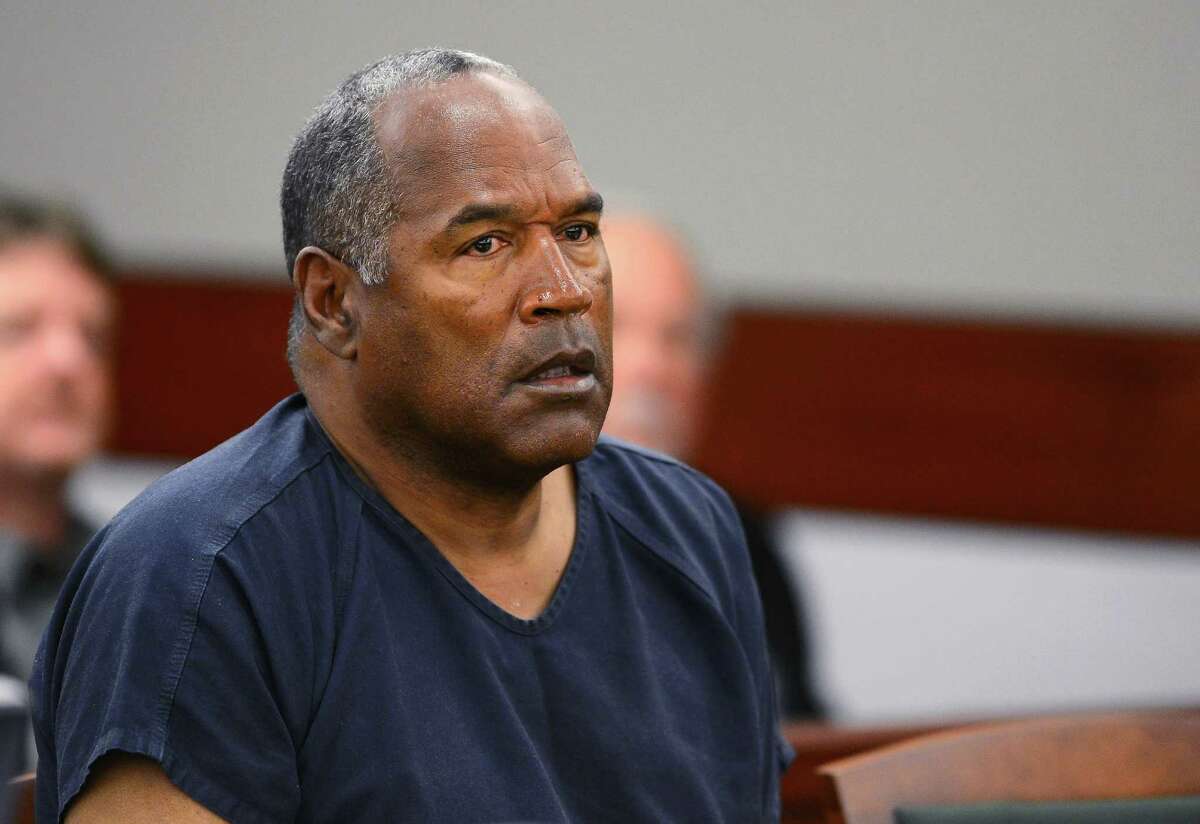 A lawyer for O.J. Simpson (shown in a 2013 court hearing) says the imprisoned former football star isn't happy with ads and interviews about a cable TV series focusing on his 1995 murder acquittal in Los Angeles, but he's not upset about the way he's depicted by Cuba Gooding Jr. (right, in a scene from “The People v. O.J. Simpson: American Crime Story,” also starring John Travolta and David Schwimmer).