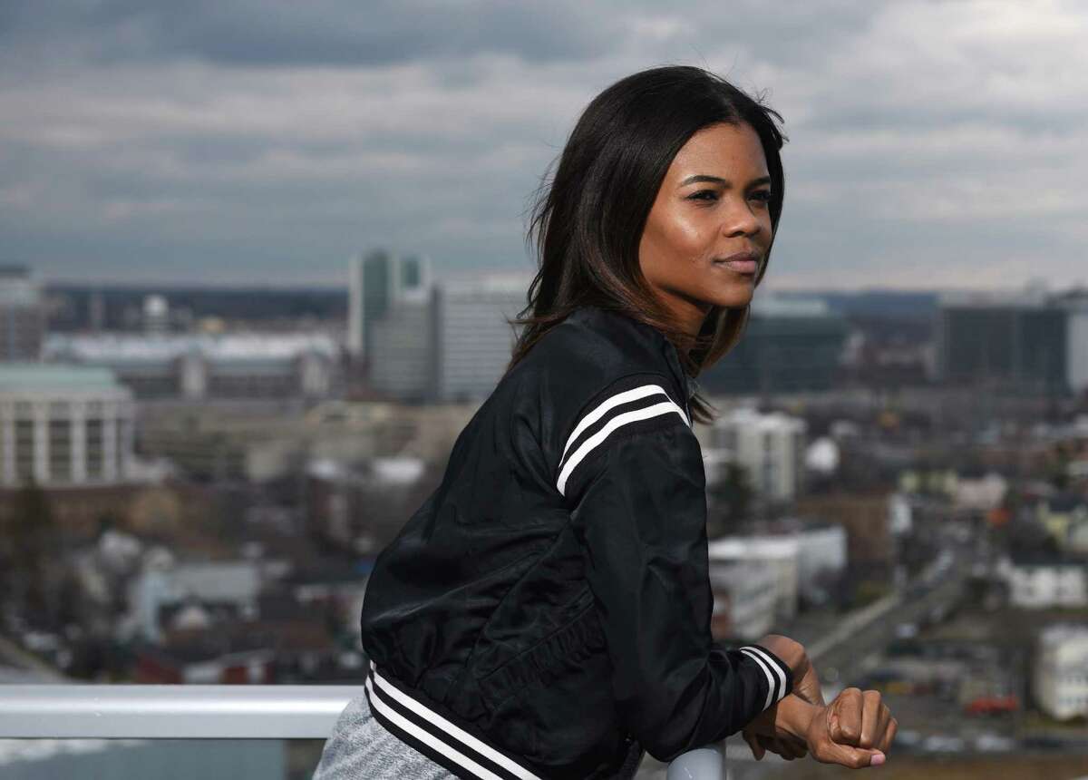 Degree180 CEO Candace Owens poses overlooking the city from her home office in Stamford.