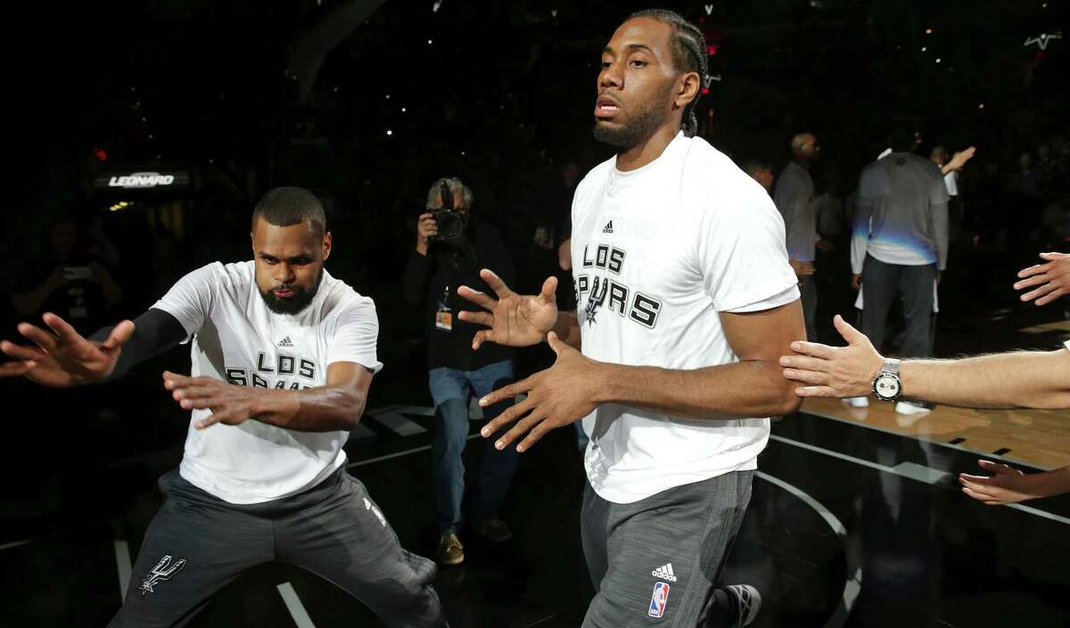 Patty Mills accentuates the introduction of Kawhi Leonard as the Spurs host the Pistons at the AT&T Center on March 2, 2016.