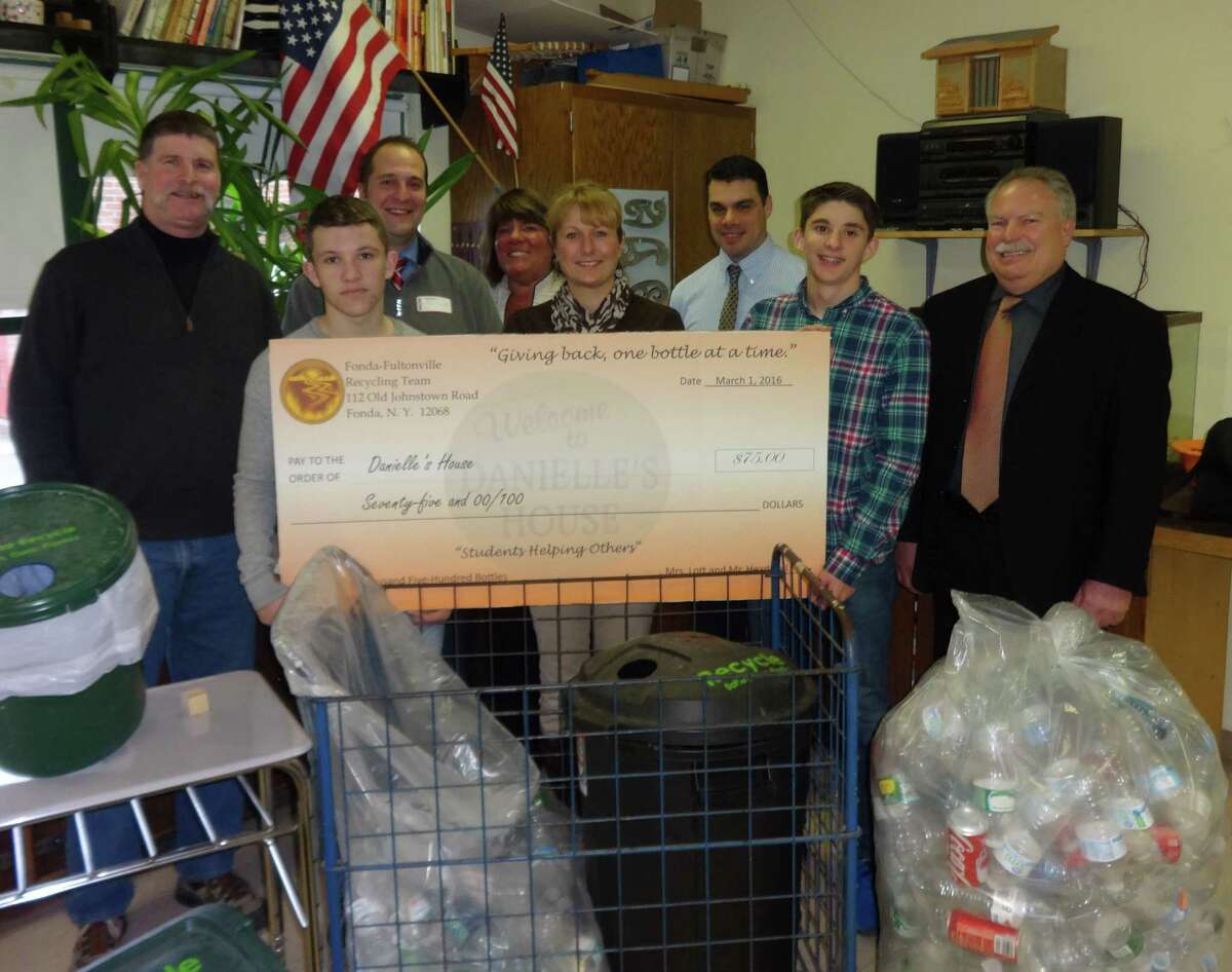 Students from the Fonda-Fultonville High School present Danielle's House with a check for $75, money that was collected from returning bottles and cans during February. From left, teacher Robert Headwell, student Mason Suchocki, Montgomery County Executive Matthew L. Ossenfort, Executive Director of IPH Janine Robitaille, teacher Sherri Lott, Middle School Principal David Zadoorian, student Joseph Wilder and Social Services Commissioner Michael McMahon. Not pictured is High School Principal Aaron Grady, who has also fully supported the effort. (Submitted photo)