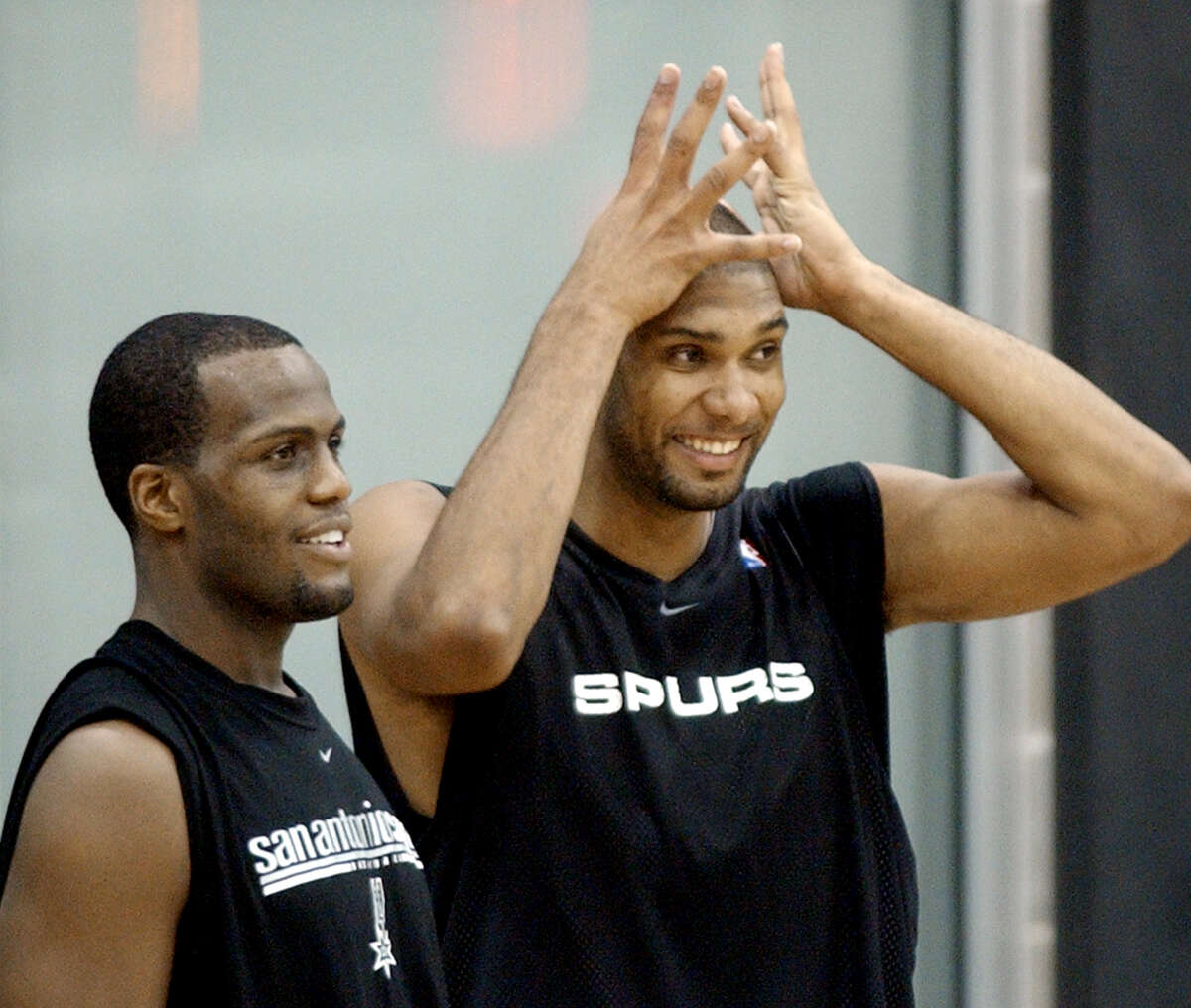 Spurs forward Tim Duncan, right, with forward Malik Rose, jokes with teammates during the first day of training camp at the team’s practice facility in San Antonio on Sept. 30, 2003.