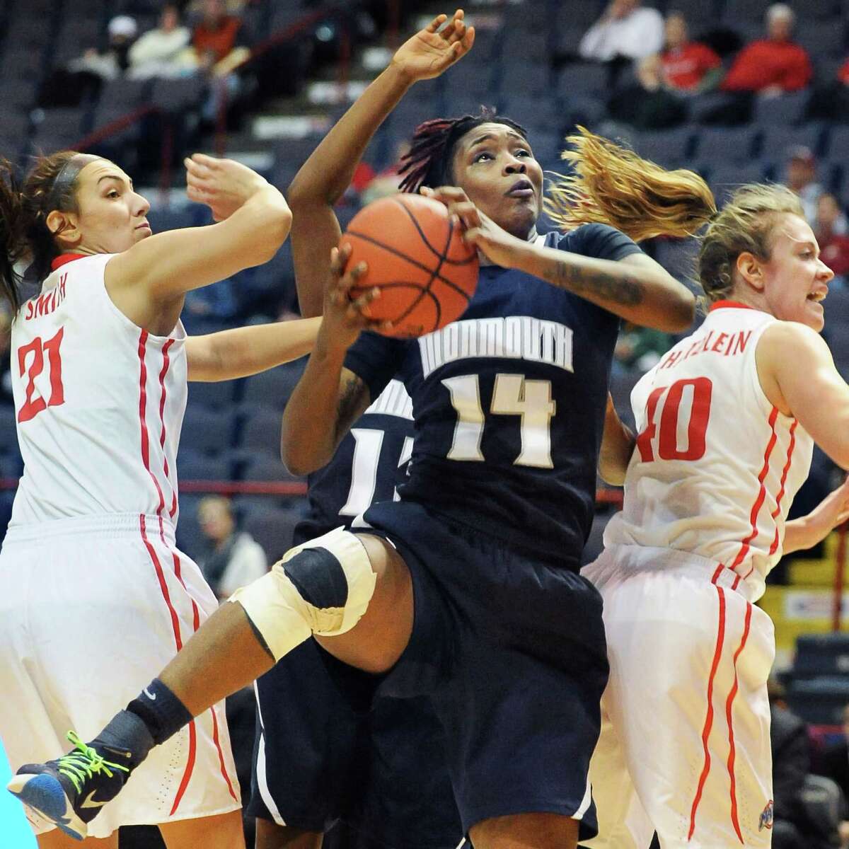 Monmouth's # 14 Christina Mitchel beats out Fairfield's #21 Casey Smith , left, and #40 Kristin Schatzlein, right, to a rebound during their MAAC women's quarterfinal at the Times Union Center Saturday March 5, 2016 in Albany, NY. (John Carl D'Annibale / Times Union)