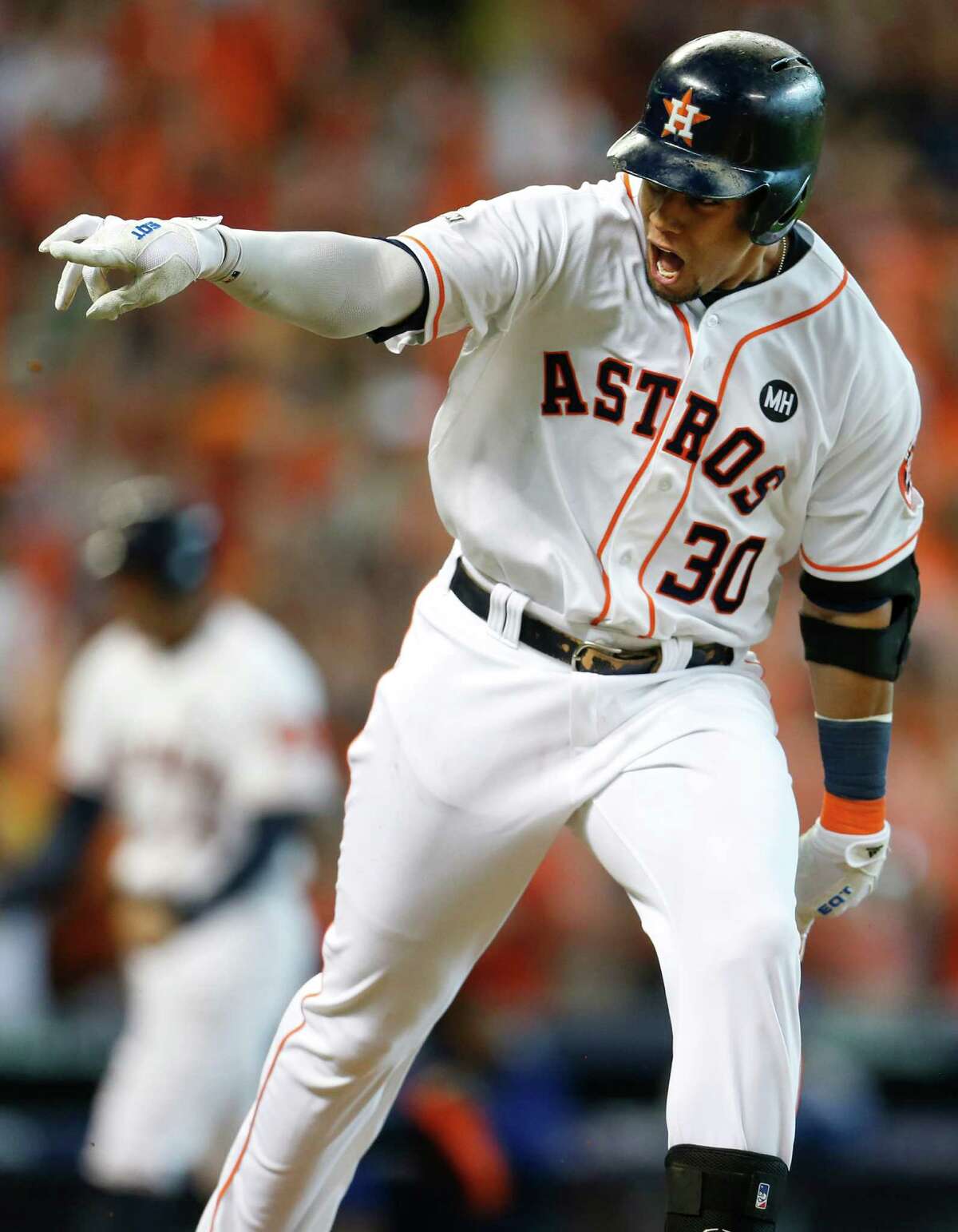 Houston Astros center fielder Carlos Gomez (30) points to the dugout after hitting an RBI single, scoring George Springer, off Kansas City Royals starting pitcher Edinson Volquez during the sixth inning of Game 3 of the American League Division Series at Minute Maid Park on Sunday, Oct. 11, 2015, in Houston. ( Karen Warren / Houston Chronicle )