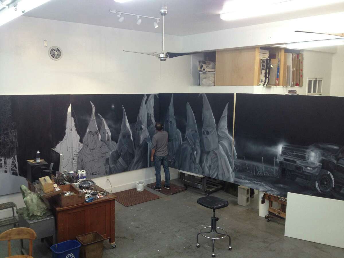 Artist Vincent Valdez at work on his new painting "The City" in his near West Side studio.