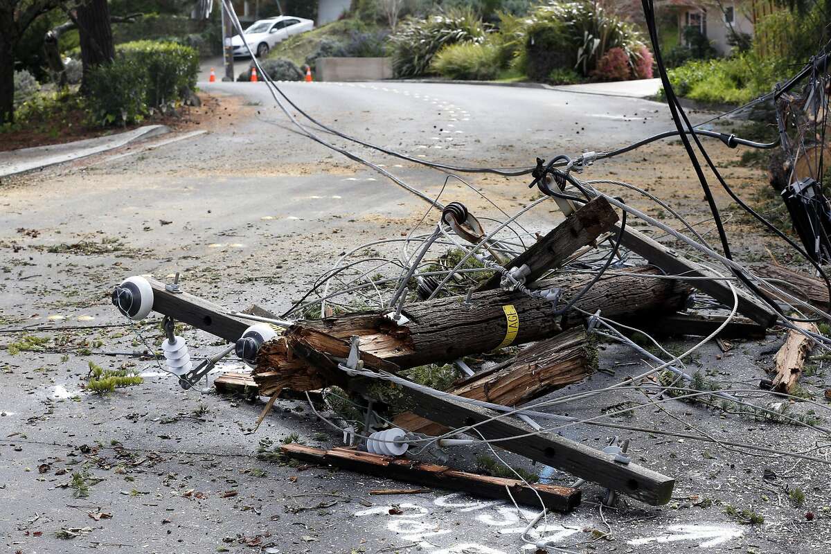 Downed power lines and a broken pole block Via Roble in Lafayette, California, on Sunday, March 6, 2016.