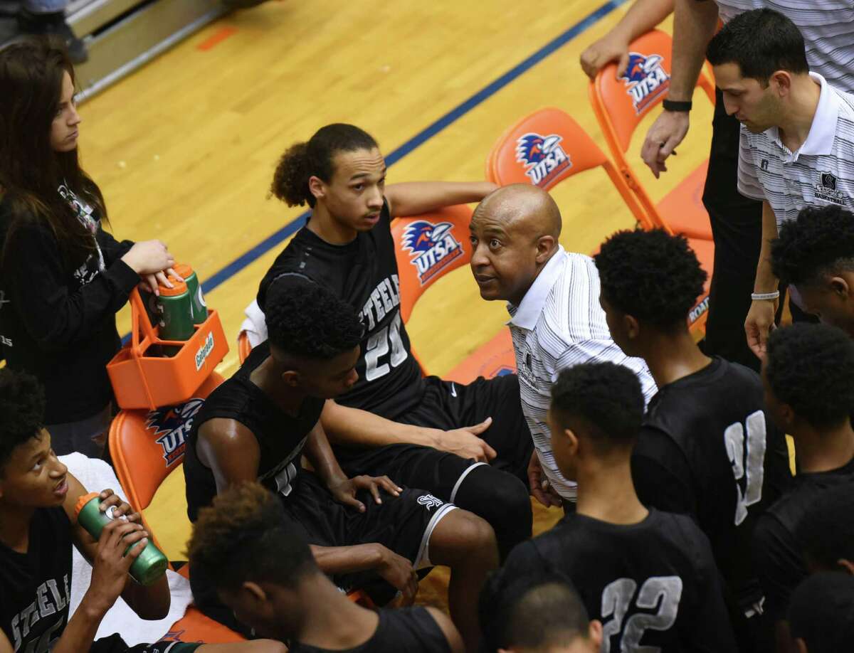 Steele head coach Lonny Hubbard speaks with his team during a timeout of their Region IV-6A basketball championship game against Laredo United at the UTSA Convocation Center on March 5, 2016.