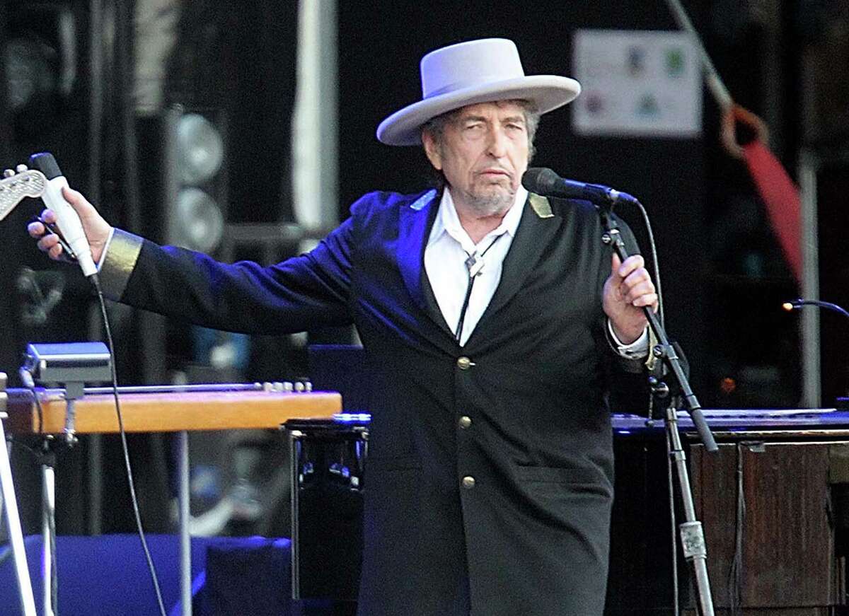 FILE - This July 22, 2012 file photo shows U.S. singer-songwriter Bob Dylan performing on stage at "Les Vieilles Charrues" Festival in Carhaix, western France. The archives of Dylan have been acquired by the George Kaiser Family Foundation and the University of Tulsa and will be permanently housed in Tulsa. Kaiser Foundation director Ken Levit and university President Steadman Upham announced the acquisition Wednesday, March 2, 2016. (AP Photo/David Vincent, file) ORG XMIT: NY114