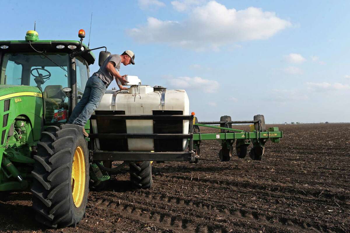 Kurt Rossow adds fungicide to fertilizer as he works a 120-acre field planting cotton southwest of Beeville, Texas, Wednesday, March 2, 2016. Texas leads the nation in production of cotton, which has plummeted in price as other nations step up production and stretchy manmade fibers enjoy a fashion moment reminiscent of the 1970s. Cotton growers are facing hard times and are hoping they can reclassify the product as an oilseed to make it eligible for subsidies that were lost in a trade dispute with Brazil.