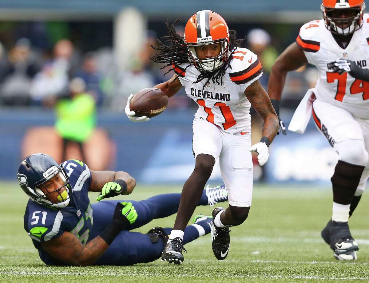Browns' Travis Benjamin evades a tackle attempt from Bruce Irvin during the first quarter of the Seahawks game against Cleveland, Sunday, Dec. 20, 2015 at CenturyLink Field. The Seahawks won 30-13.