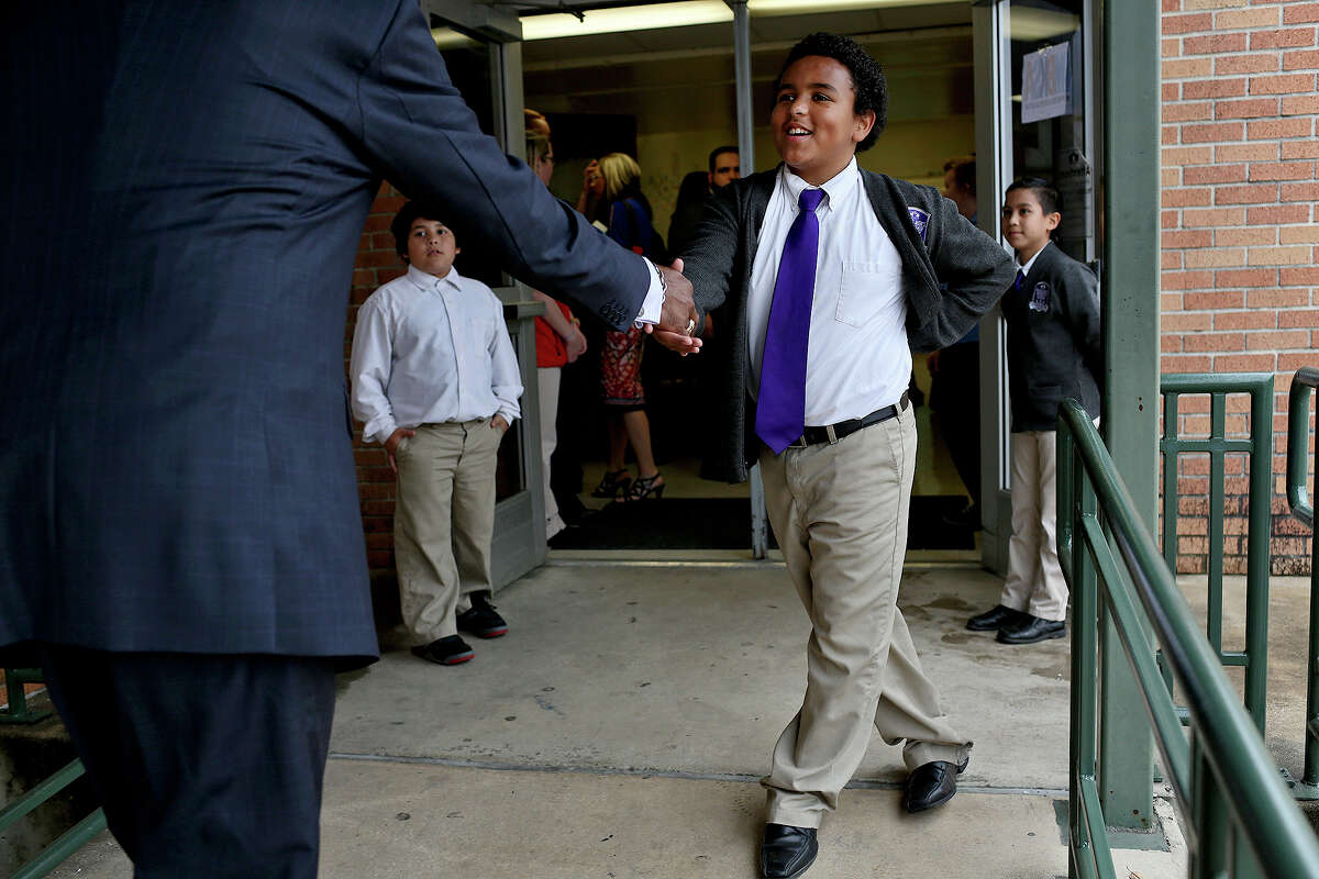 Young Men's Leadership Academy fifth-grader Francisco Vega, 11, welcomes guests to the My Brother's Keeper San Antonio event at his school on Monday.