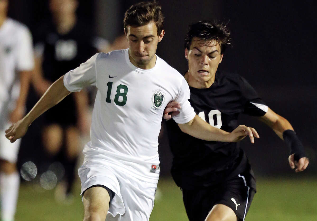 Reagan’s Pablo Galvan (left) and Clark’s Jake Peterson chase after the ball during second half action of their Class 6A second round playoff game on April 2, 2015 at Blossom Soccer Stadium.