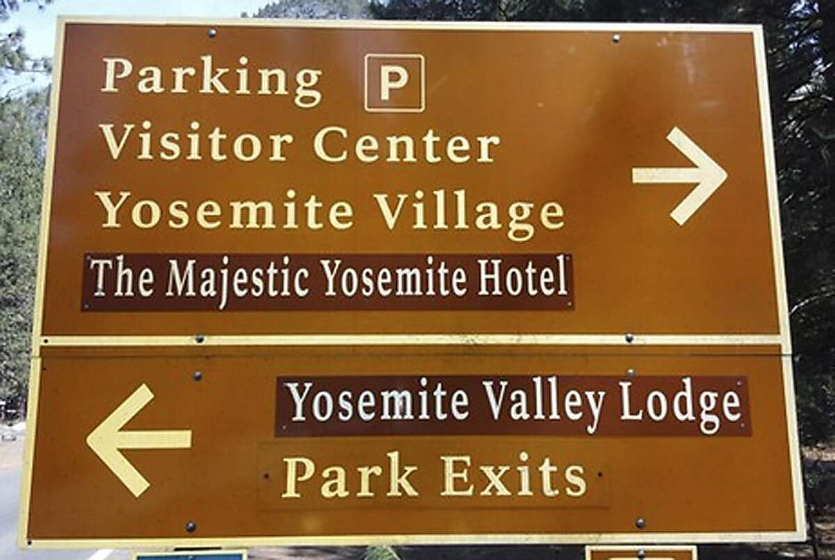 A traffic sign is seen with changes to reflect new names for The Ahwahnee Hotel and Yosemite Lodge at the Falls on Tuesday, March 1, 2016, in Yosemite National Park, California. The prices of Yosemite National Park souvenirs have been slashed in half, and road signs directing visitors to iconic attractions have been switched. The changes took place at midnight Monday amid a bitter legal dispute between government officials and Delaware North, which operated many of the popular attractions from 1993 until Monday when competitor Aramark took over. (Rory Appleton/The Fresno Bee via AP) LOCAL PRINT OUT (VISALIA TIMES-DELTA, REEDY EXPONENT, KINGBURG RECORDER, SELMA ENTERPRISE, HANFORD SENTINEL, PORTERVILLE RECORDER, MADERA TRIBUNE, THE BUSINESS JOURNAL FRENSO); LOCAL TELEVISION OUT (KSEE24, KFSN30, KGE47, KMPH26); MANDATORY CREDIT
