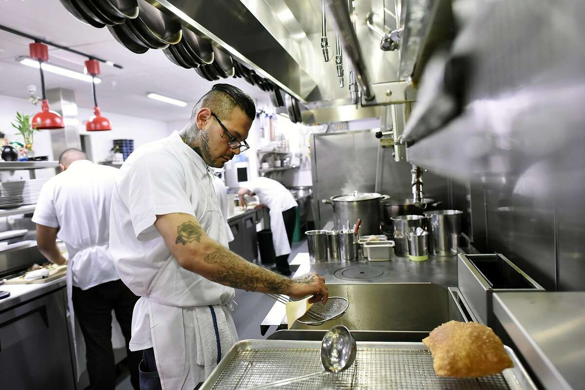 Edward Martinez, a former Fresno Bulldogs gang member who is now the executive pastry chef, deep fries dough for fry bread in the kitchen at Cadence restaurant in San Francisco, CA Wednesday, March 2, 2016.