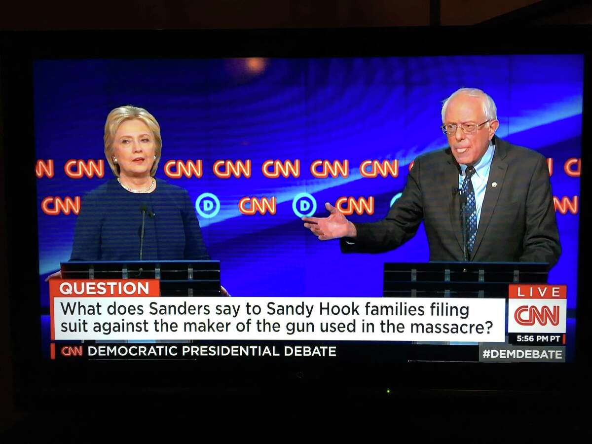 Former Secretary of State Hillary Clinton and U.S. Sen. Bernie Sanders of Vermont clashed over legislation that allows victims of gun violence to sue firearms manufacturers during a CNN Democratic presidential debate Sunday, March 6, 2016. Still photo from CNN broadcast.