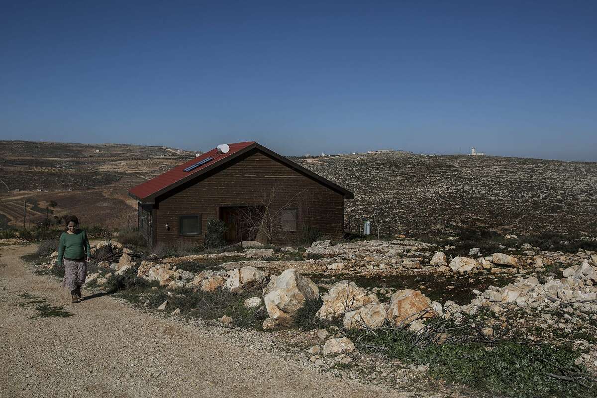 In this photo taken Sunday, Jan. 17, 2016, Inbal Zeev walks by her guest house advertised on Airbnb international home-sharing site in Nofei Prat settlement at the West Bank. Palestinians say that by contributing to the settlement economy, Airbnb, like other companies doing business there, is perpetuating the expansion of Israel�s settlement enterprise. The criticism puts the travel site in the crosshairs of a burgeoning boycott movement and highlights the intricacies of the sharing economy in a legal anomaly such as the settlements, where residents are Israeli citizens but the land is occupied. (AP Photo/Tsafrir Abayov)