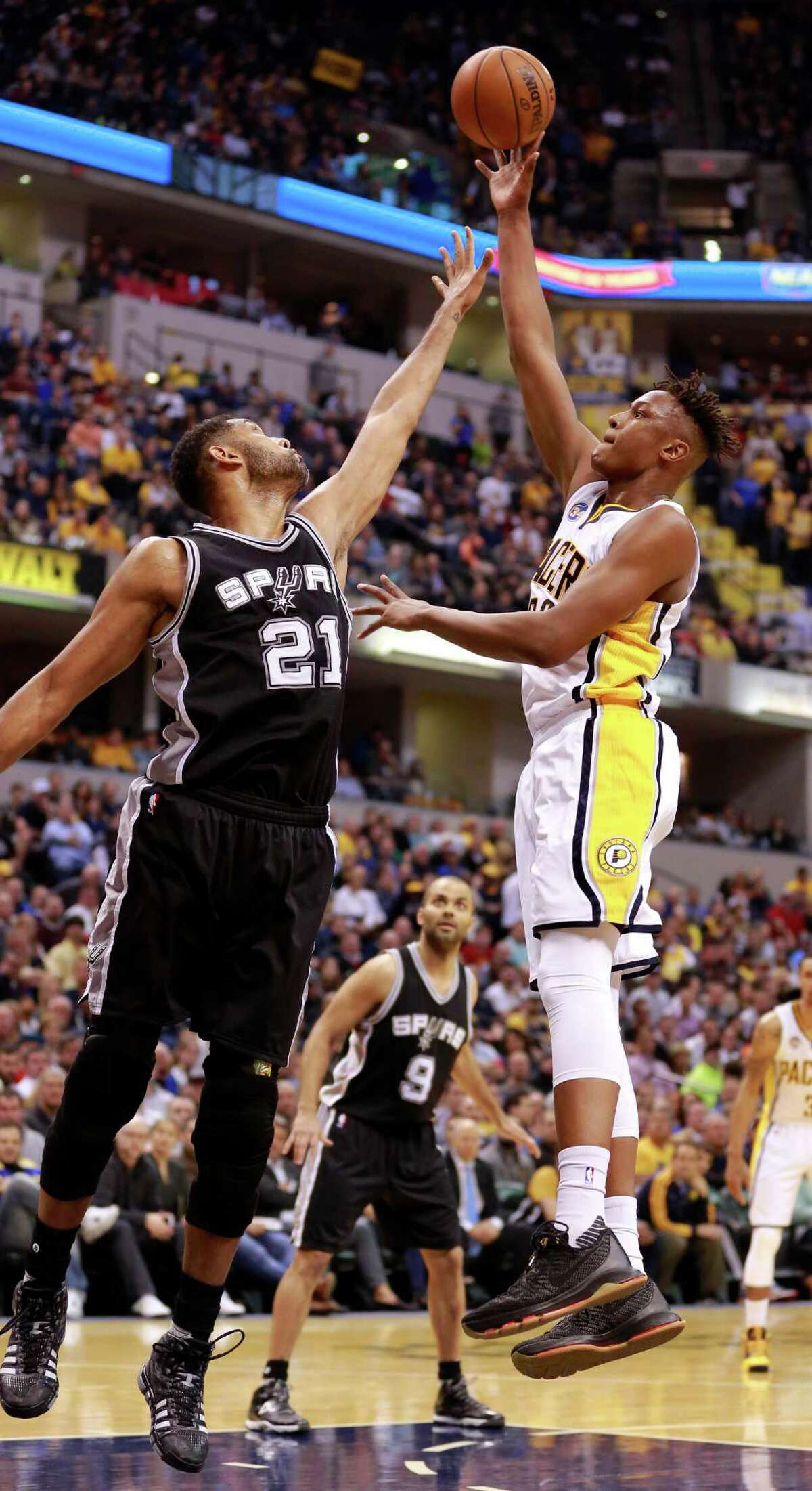Indiana Pacers forward Myles Turner, right, shoots the basketball over San Antonio Spurs forward Tim Duncan (21) in the first half of an NBA basketball game, Monday, March 7, 2016, in Indianapolis. (AP Photo/R Brent Smith)