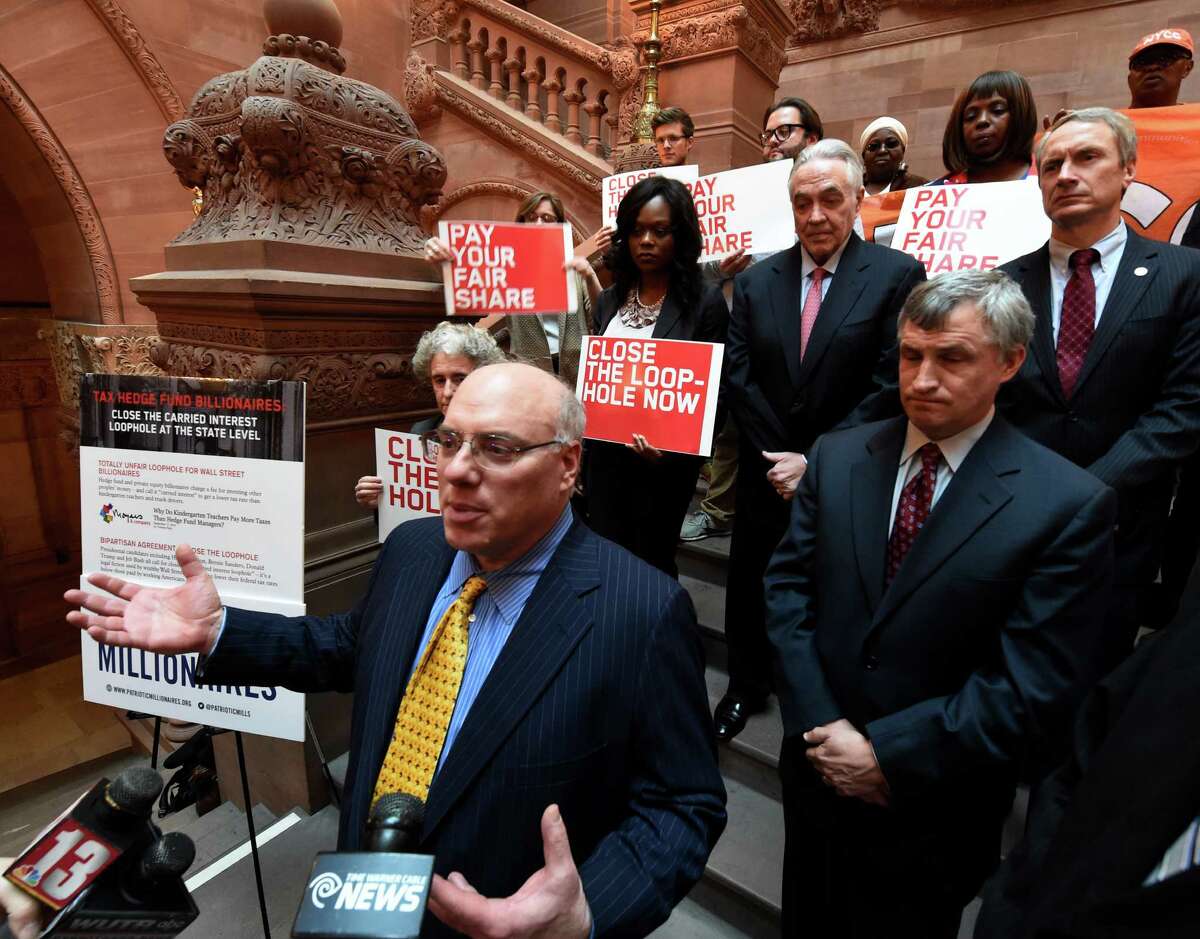 Patriotic Millionaires Chair Morris Pearl and a group of fellow millionaires press for legislation to close tax loopholes that provide Wall Street money managers with preferential tax treatment on the Million Dollar Staircase in the State Capitol Monday Mar. 7, 2016 in Albany, N.Y. (Skip Dickstein/Times Union)