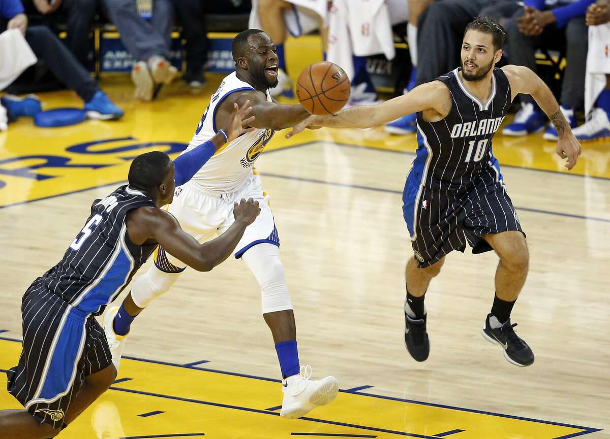 Golden State Warriors' Draymond Green beats Orlando Magic's Evan Fournier and Victor Oladipo to a loose ball in 1st quarter during NBA game at Oracle Arena in Oakland, Calif., on Monday, March 7, 2016.