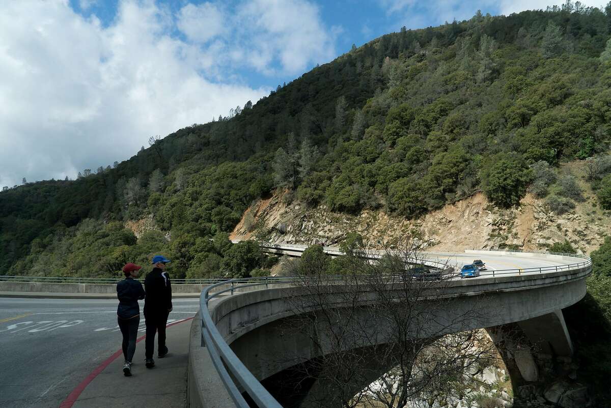 People cross Highway 49 to view the South Yuba River in Nevada City.