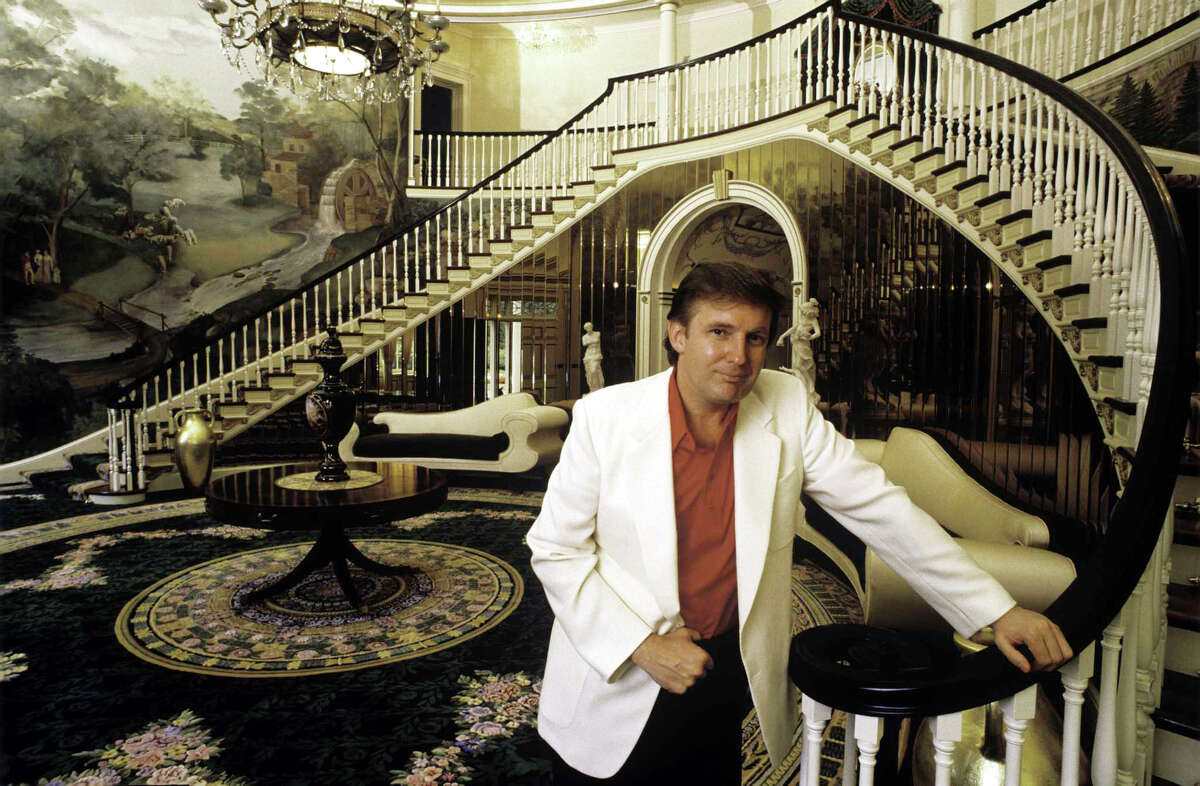 Donald Trump, real estate mogul, entrepreneur, and billionare poses in the foyer of his home in August 1987 in Greenwich, Connecticut.