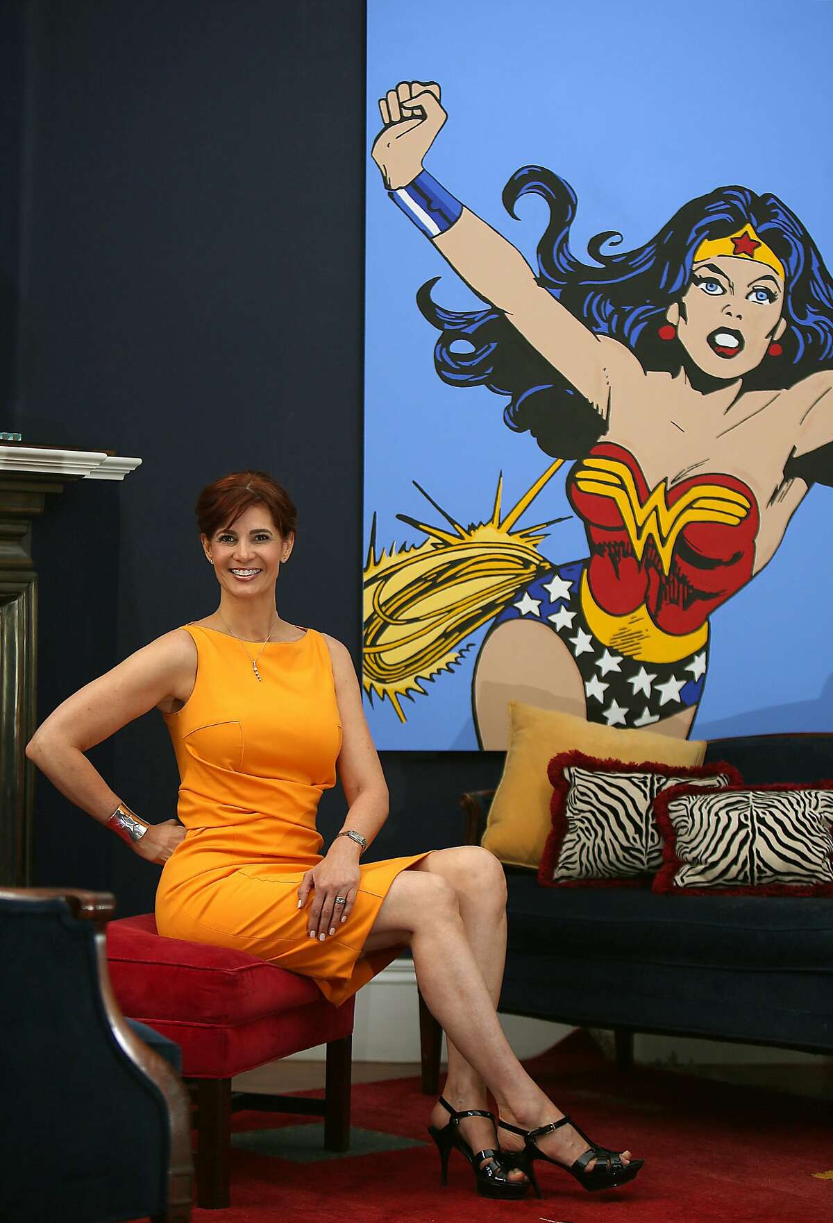 Jenny Dearborn shows her painting of a wonder woman cartoon displayed at home in Palo Alto, California, on Wednesday, February 24, 2016. She has four degrees including Stanford and UC Berkeley, has 75,000 employees worldwide, and paints superheroes in her spare time.