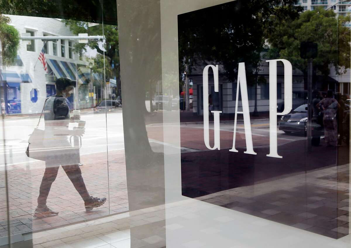 In this Saturday, Aug. 15, 2015, photo, a pedestrian walks past a Gap store in Miami. Gap reports earnings on Thursday, Feb. 25, 2016. (AP Photo/Lynne Sladky)