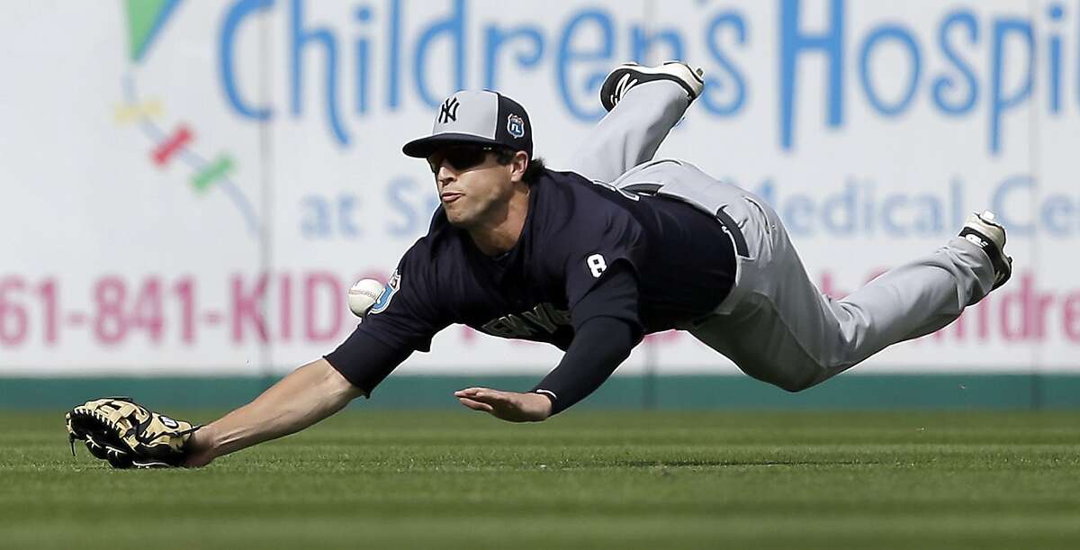 New York Yankees center fielder Dustin Fowler dives but cannot catch a single hit by Miami Marlins' Don Kelly during the seventh inning of an exhibition spring training baseball game Tuesday, March 8, 2016, in Jupiter, Fla. The Marlins won 1-0. (AP Photo/Jeff Roberson)
