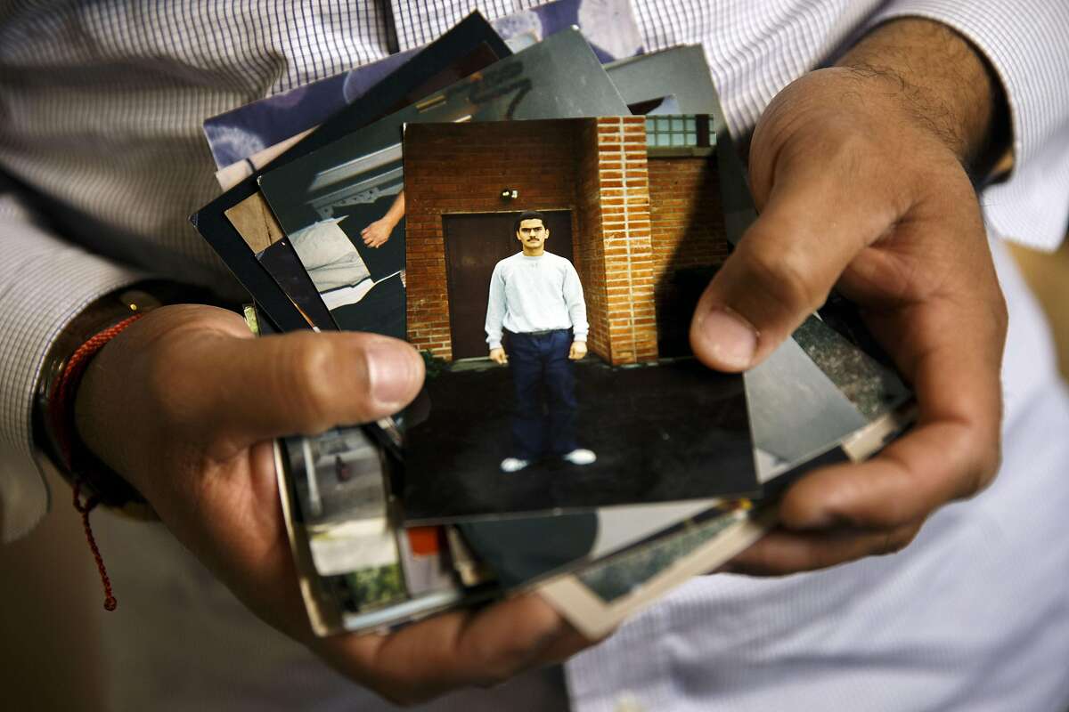 Franky Carrillo, arrested at age 16 and wrongly convicted in 1991 of murder before spending 20 years in prison, holds a photograph of himself at age 18 stands for a portrait at his home on Tuesday, March 8, 2016 in the Echo Park neighborhood of Los Angeles, Calif. Carrillo said that while in prison the photographs he received in the mail from family and friends were very important to him. "These pictures (were) moments in people's lives that people would send me... I would sort of grow with them and feel that I was there," said Carrillo. "They reminded me that I was aging along with the people that were on the outside." Photo by Patrick T. Fallon/Special to The Chronicle