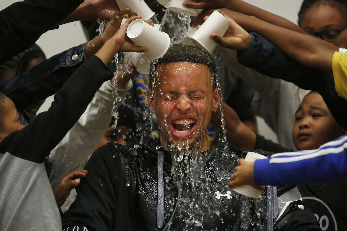 Students pour water onto Stephen Curry's head during an event at Martin Luther King Jr. Elementary School wherein Curry promoted drinking water and healthy eating in partnership with his sponsor Brita March 8, 2016 in Oakland, Calif.