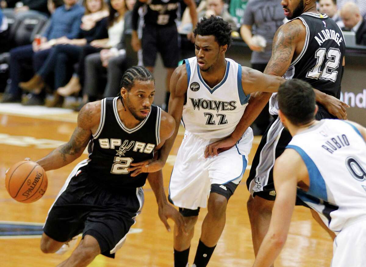 San Antonio Spurs forward Kawhi Leonard (2) drives on Minnesota Timberwolves guard Andrew Wiggins (22) on a pick by Spurs' LaMarcus Aldridge (12) during the first quarter of NBA basketball game Tuesday, March 8, 2016, in Minneapolis. (AP Photo/Andy Clayton-King)