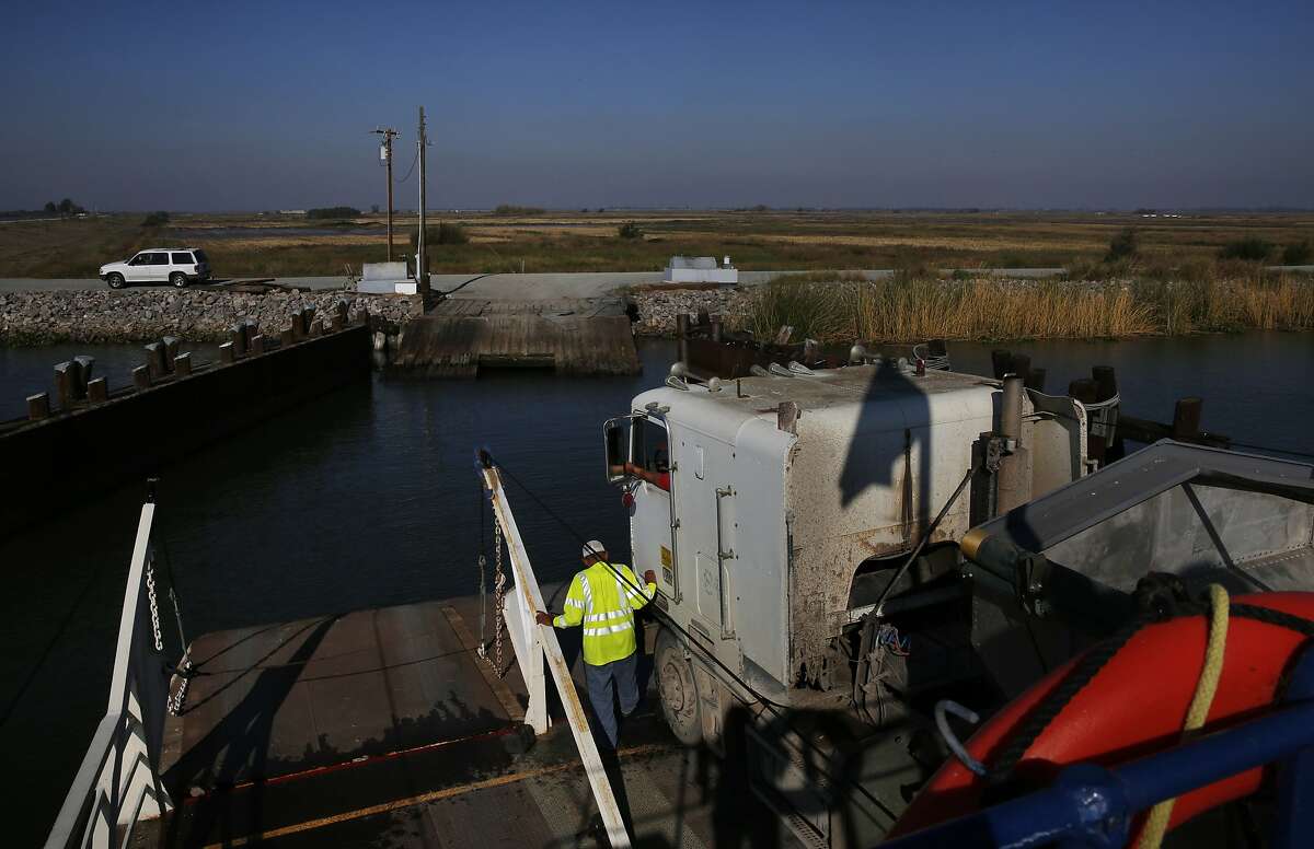 Larry Etherton prepares to unload a massive transport truck from a ferry on Middle River that will be filled with corn on Webb Tract Island Nov. 13, 2015 near Rio Vista, Calif. Webb Tract Island is one of two Islands that Barajas manages for a local farmer. Barajas lives on Bouldin Island.