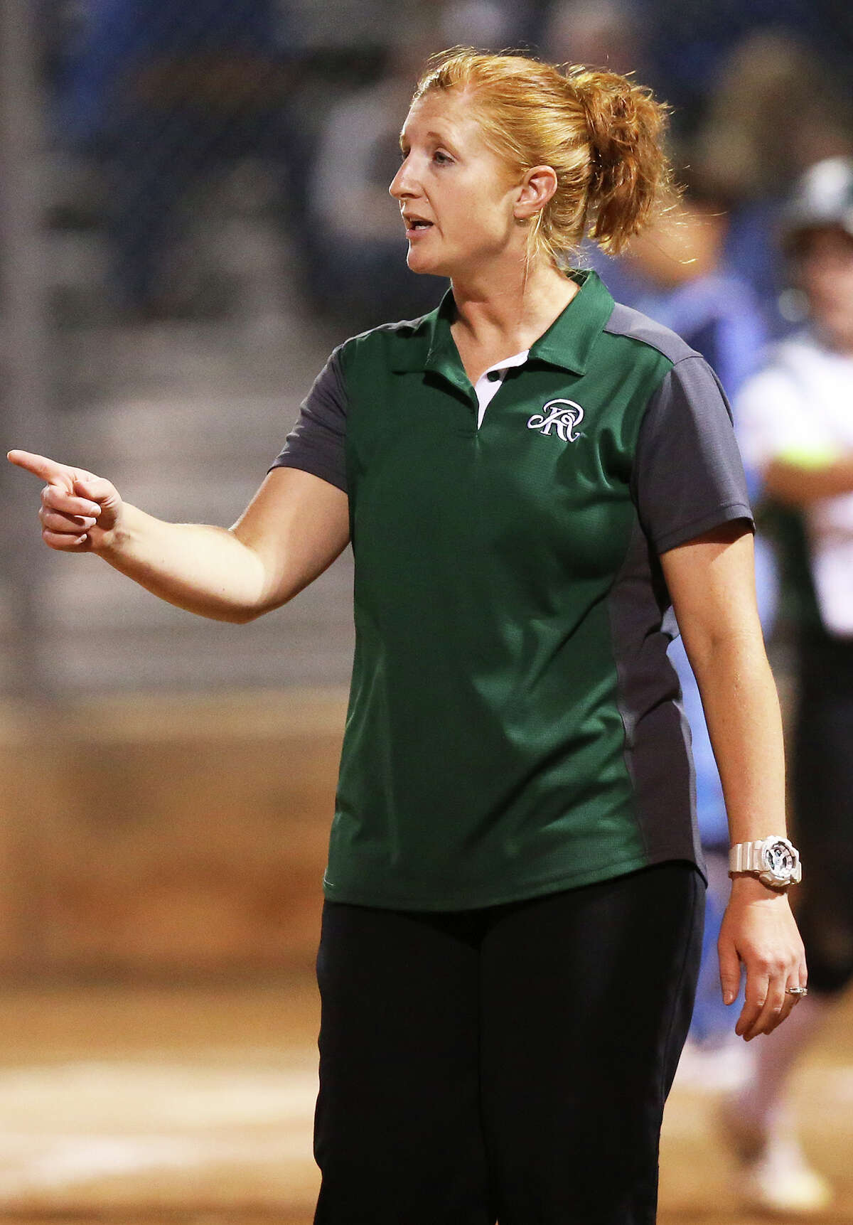 Rattler coach Jill Cupp directs players in the field as Johnson beats Reagan 7-1 in softball at the Northeast Softball Complex on March 8, 2016.