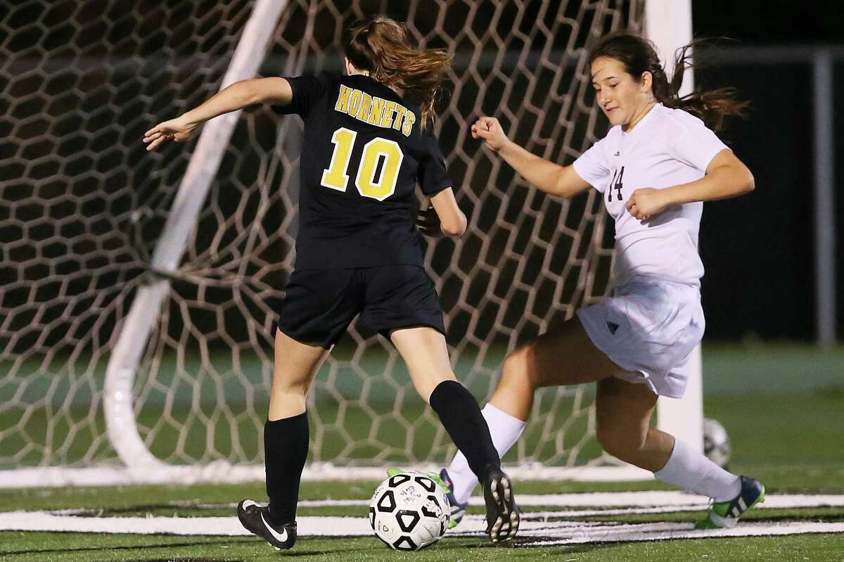 Southwest's Hanna Williamson (right) slips in to block a shot by East Central's Sadie Parker during the second half of their District 28-6A game at Southwest on Tuesday, March 1, 2016. Southwest beat East Central 1-0. MARVIN PFEIFFER/ mpfeiffer@express-news.net