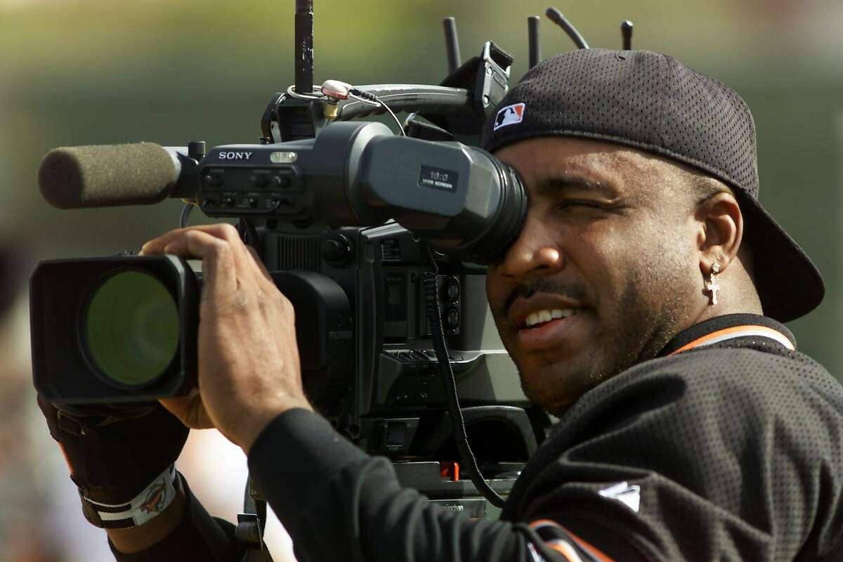 GIANTS BONDS-C-25FEB00-SP-KL ---Barry Bonds trades places with the media getting behind a TV camera, and jokes that he could be a cameraman. The Giants are in Spring Training at Indian School Park in Scottsdale. (KENDRA LUCK/SAN FRANCISCO CHRONICLE)