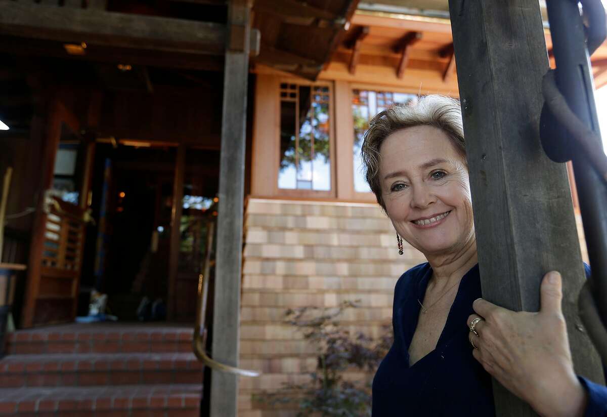 FILE - In this June 20, 2013 file photo, Alice Waters poses outside the new front entrance to her Chez Panisse restaurant in Berkeley, Calif. After a fire in March shut the doors to the famous gourmet restaurant, the eatery reopened in June. (AP Photo/Eric Risberg, File)