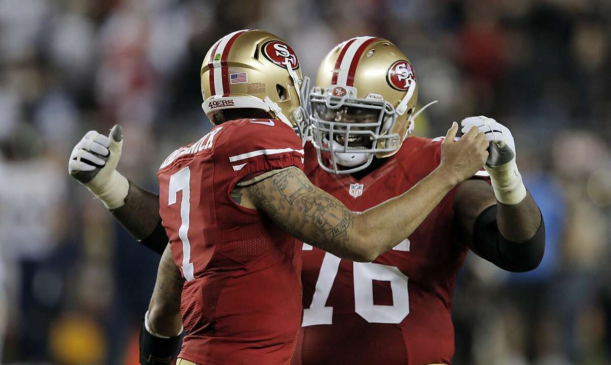 Colin Kaepernick (7) celebrates with Anthony Davis(76) after his 90-yard touchdown run during third quarter as the 49ers played the San Diego Chargers at Levi's Stadium in Santa Clara, Calif., on Saturday, December 20, 2014. The touchdown was the only score for the 49ers in the second half.