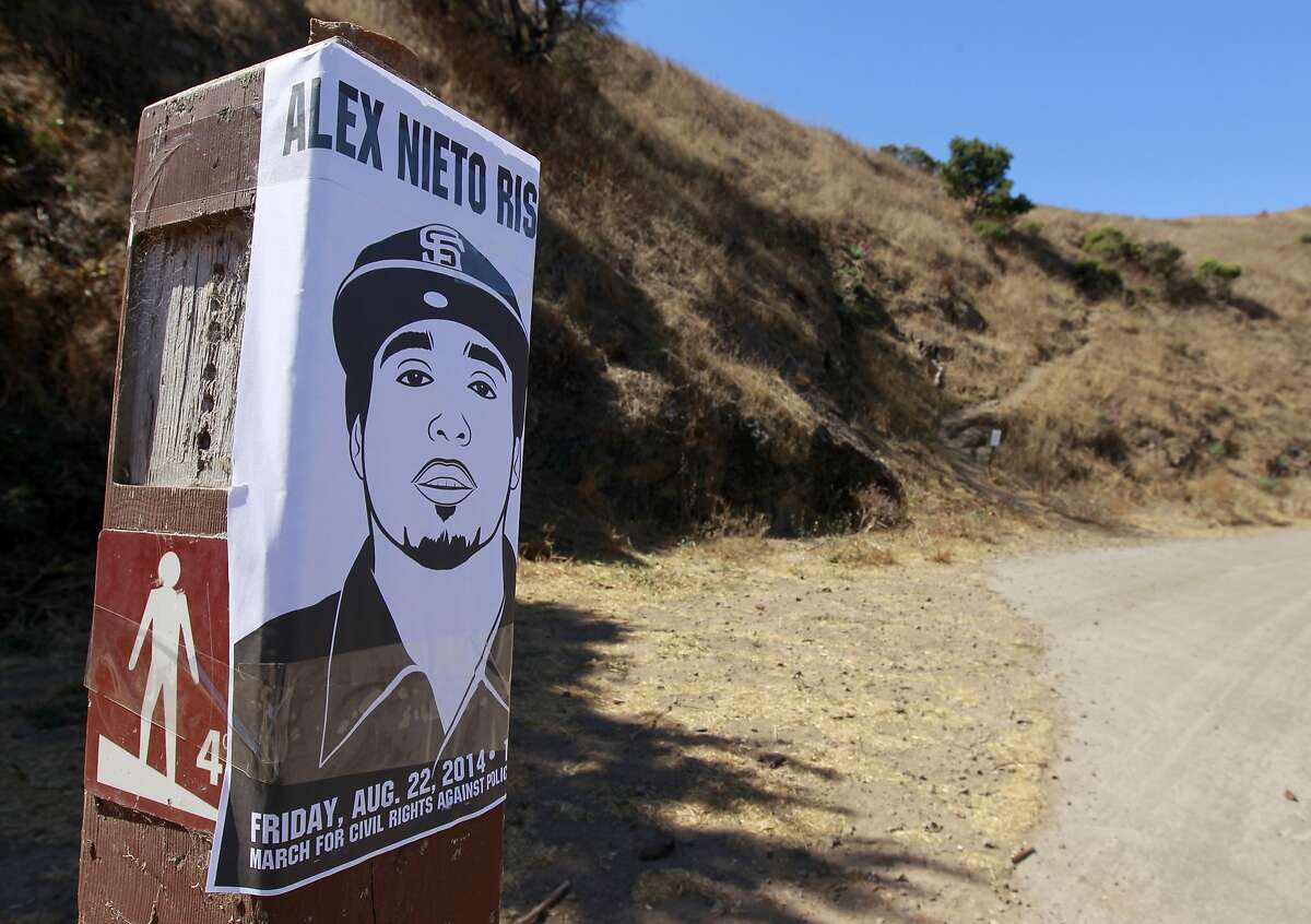 A poster is taped to a trail marker before a rally and march from Bernal Heights Park to the Federal Building by protesters to demand justice for Alex Nieto in San Francisco, Calif. on Friday, Aug. 22, 2014. The demonstrators are angry that the police shot and killed Nieto, who was holding a taser, in the park early on March 21. The family is filing a lawsuit in federal court Friday.