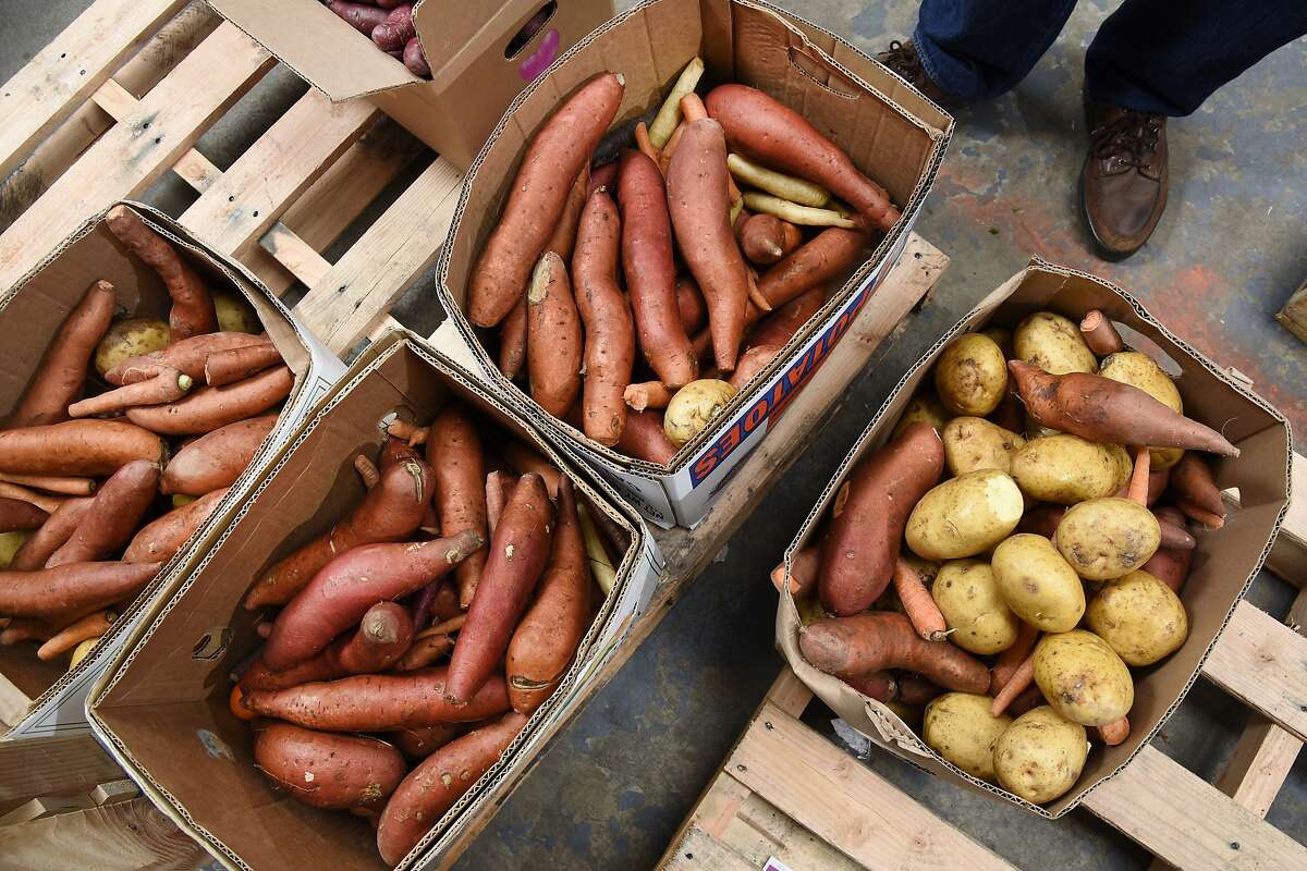 Boxes of yams and potatoes that are too damaged to be sold by Imperfect Produce are boxed for donation to local food banks, in Emeryville, CA, Wednesday March 9, 2016.