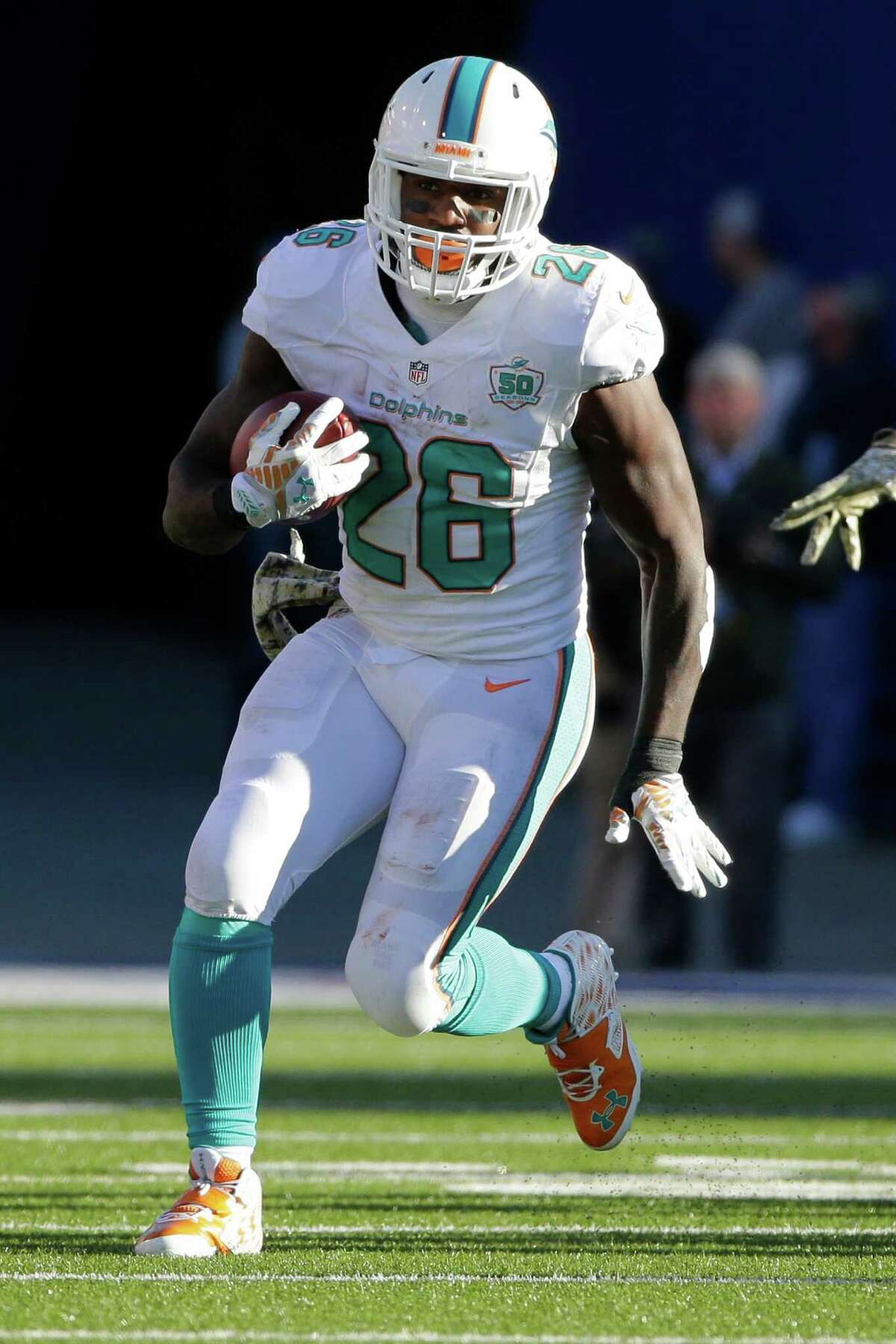 Miami Dolphins running back Lamar Miller (26) rushes during the second half of an NFL football game against the Buffalo Bills Sunday, Nov. 8, 2015, in Orchard Park, N.Y. (AP Photo/Bill Wippert)