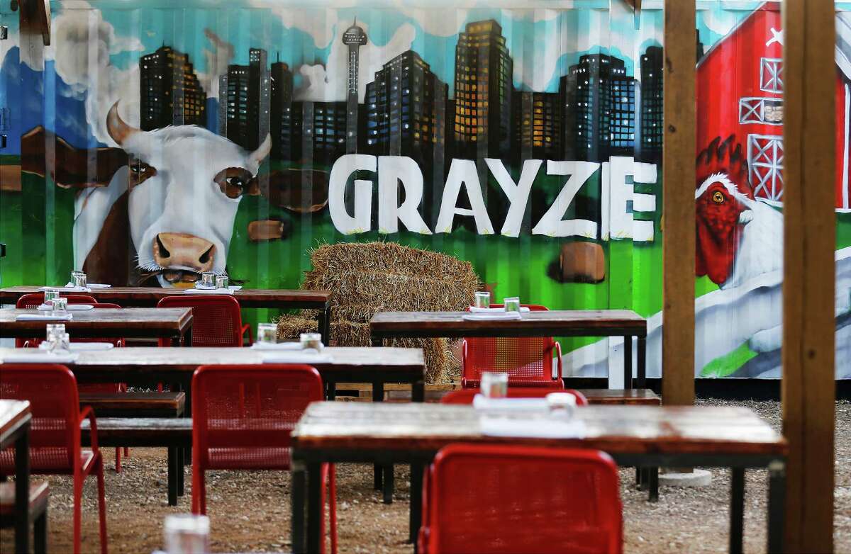 The rear patio offers plenty of seating and a fun farm-inspired mural, complete with bales of hay.