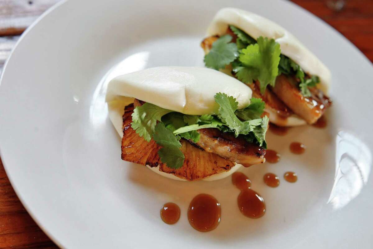 Belly Buns include glazed slow-cooked pork belly, cilantro and grilled pineapple in steamed buns.