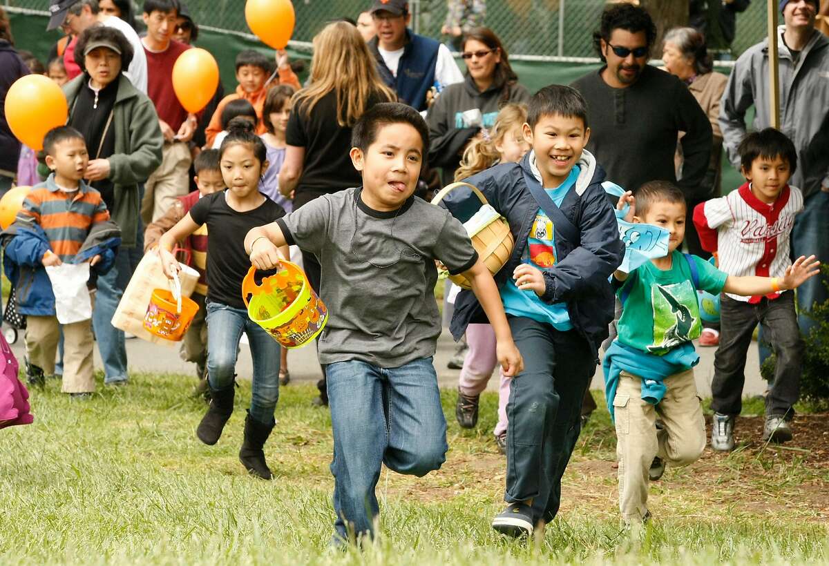 Children sprint to be the first to find Easter eggs at the Spring Eggstravaganza held in Golden Gate Park in San Francisco on Saturday.