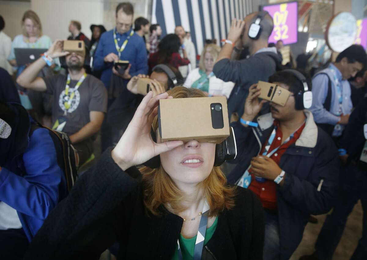 Jen Fitzpatrick, vice president engineering, and other attendees use Google Cardboard to try out the Expeditions app in a demo area during Google I/O 2015 conference at Moscone West on Thursday, May 28, 2015 in San Francisco, Calif.