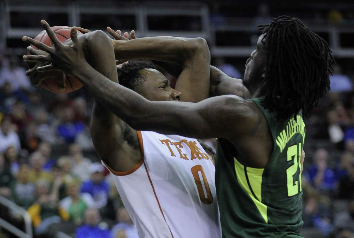 KANSAS CITY, MO - MARCH 10: Tevin Mack #0 of the Texas Longhorns looks to pass the ball against Taurean Prince #21 of the Baylor Bearsin the first half during the quarterfinals of the Big 12 Basketball Tournament at Sprint Center on March 10, 2016 in Kansas City, Missouri.