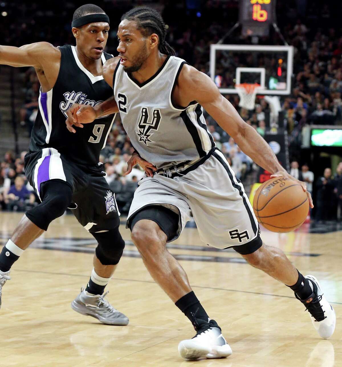 San Antonio Spurs' Kawhi Leonard drives around Sacramento Kings' Rajon Rondo during second half action Saturday March 5, 2016 at the AT&T Center. The Spurs won 104-94.