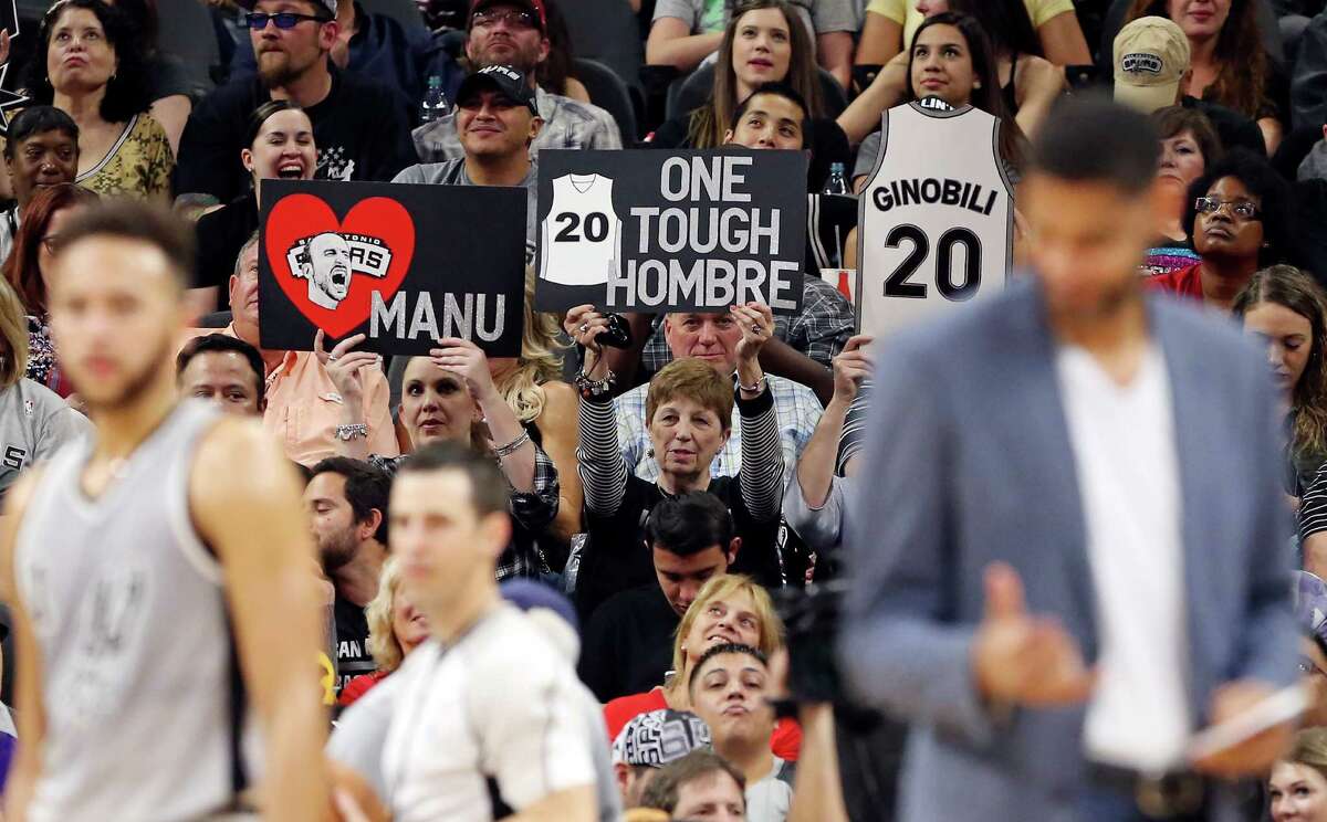 San Antonio Spurs fans hold signs for Manu Ginobili during second half action against the Sacramento Kings Saturday March 5, 2016 at the AT&T Center. The Spurs won 104-94.