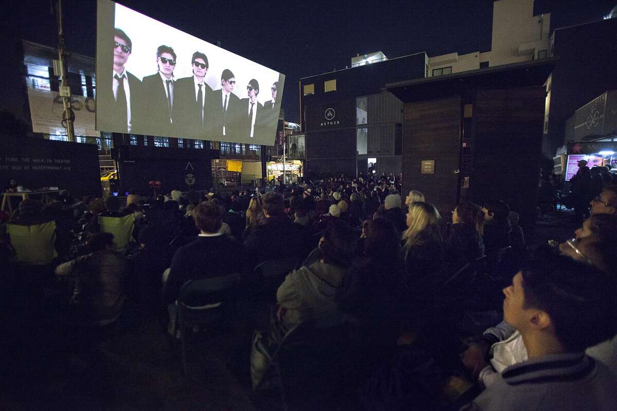 A couple hundred people gather for the Proxy Fall Film Festival near Octavia and Hayes streets, Friday, Nov. 13, 2015, in San Francisco, Calif. The free walk-in movie theatre featured "The Wolfpack."