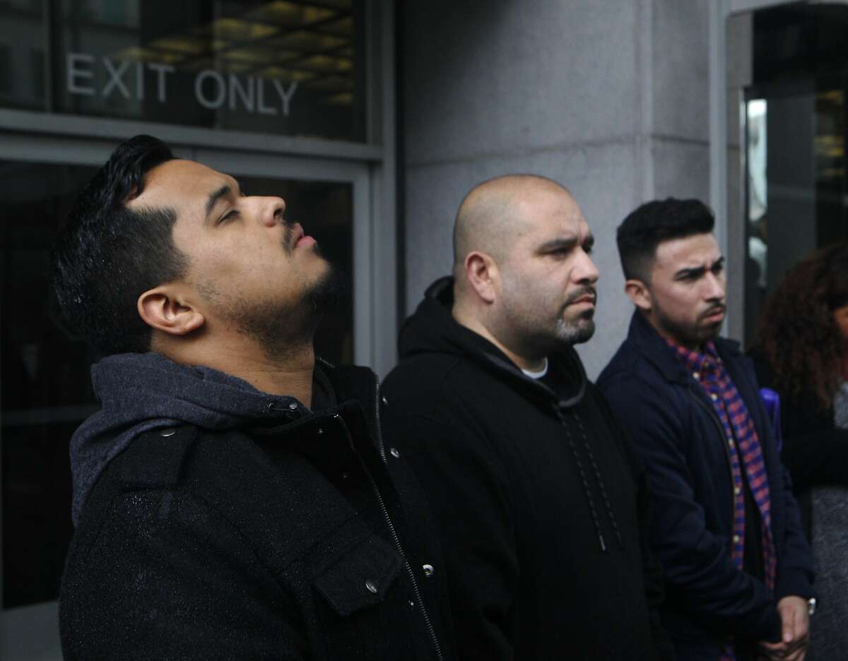Ely Flores, left, and Oscar Salinas, center, stand outside of the San Francisco Federal Courthouse on March 10, 2016 after the verdict of Not Guilty for the federal civil rights trial. The trial covered conflicting versions of what happened when four officers shot and killed 28-year old Alex Nieto at Bernal Heights Park on March 21, 2014.